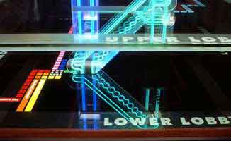 Zoom on a architectural signage, in colored neon, elegantly reproducing the 3-D structure of a building | CRA Design