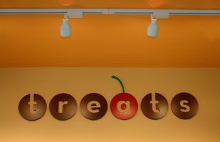 the Architectural signage based on the logo is part of Treats' restaurant branding and visual identity | Coco Raynes Associates, Inc.