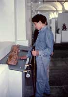 Museum Exhibit Design by Coco Raynes Associates, Inc in the Museo Nacional de Colombia. Picture 5: A Raynes rail - Braille and Audio Handrail is installed next to a piece and used by a visually impaired visitor 