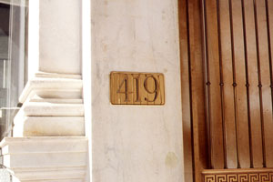 Elegant Numeral  on the side of a building part of the architectural signage design system | CRA designs